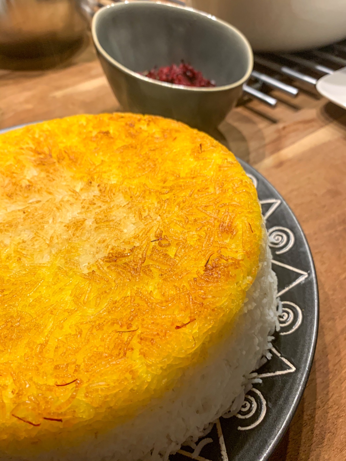 Close-up of golden, saffron-streaked tahdig rice crust on a plate